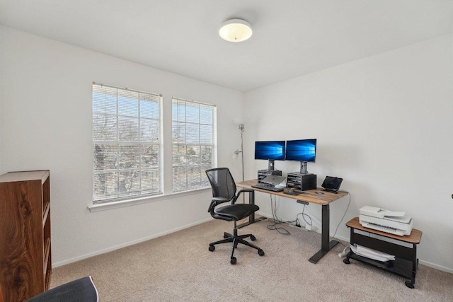 carpeted office featuring baseboards