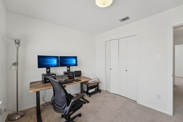 carpeted office space featuring baseboards and visible vents