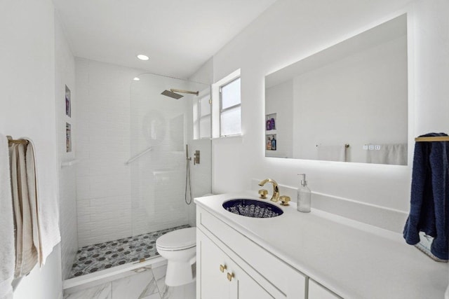 full bath featuring tiled shower, toilet, marble finish floor, and vanity