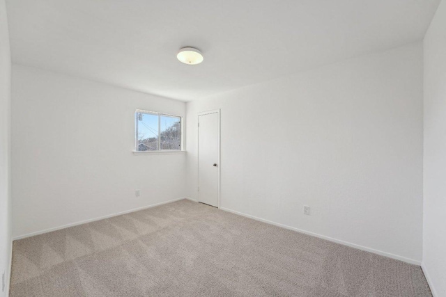 5217 Summerset Trl, Austin, TX 78749 - spare room featuring light carpet and baseboards