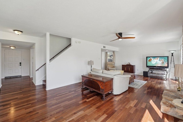 living area featuring stairs, wood finished floors, baseboards, and a ceiling fan