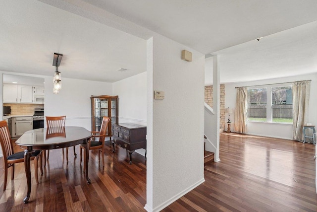 dining space with stairway, baseboards, and dark wood-style flooring