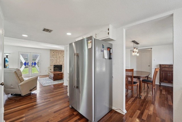 5217 Summerset Trl, Austin, TX 78749 - kitchen featuring freestanding refrigerator, dark wood-type flooring, white cabinets, open floor plan, and a fireplace
