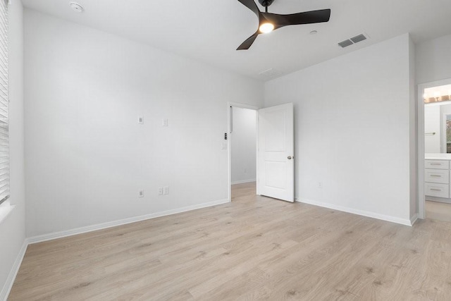 unfurnished bedroom with a ceiling fan, baseboards, visible vents, light wood finished floors, and connected bathroom