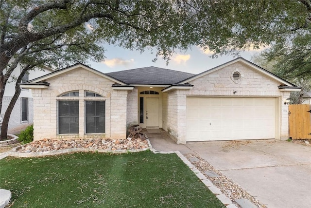 single story home with a front yard, fence, an attached garage, a shingled roof, and concrete driveway