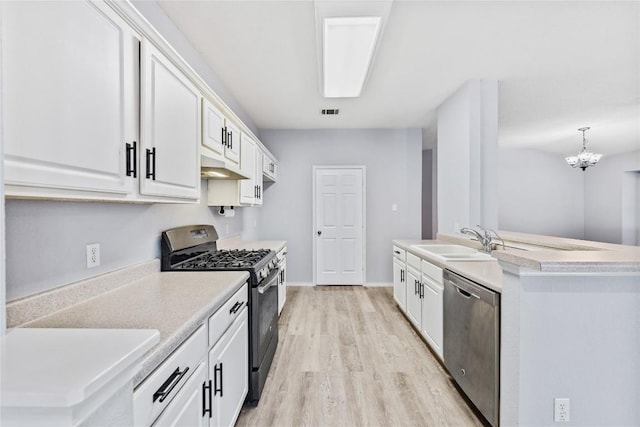 kitchen featuring light countertops, appliances with stainless steel finishes, light wood-style floors, white cabinets, and a sink