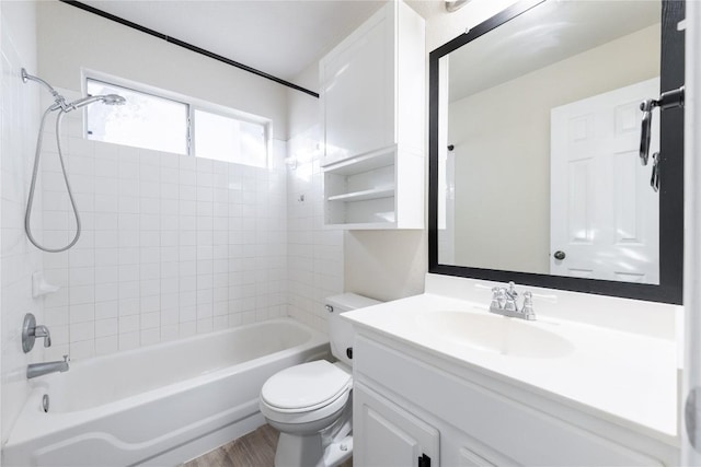 full bath featuring wood finished floors, toilet, vanity, and washtub / shower combination