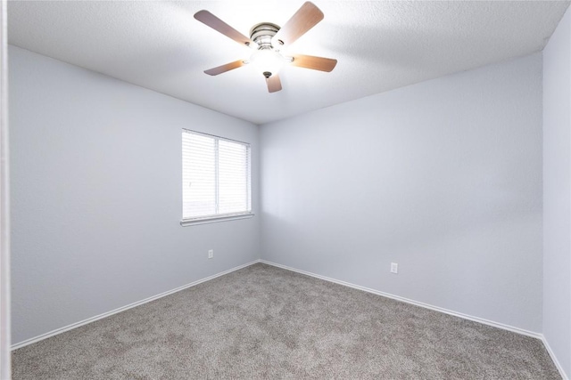 spare room with baseboards, carpet, a ceiling fan, and a textured ceiling