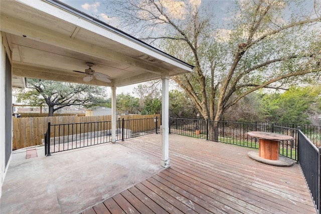 wooden terrace with a ceiling fan and fence