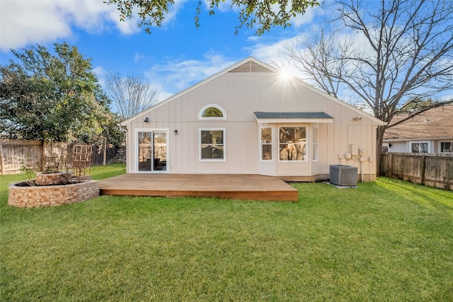 rear view of house featuring cooling unit, a deck, a yard, and a fenced backyard