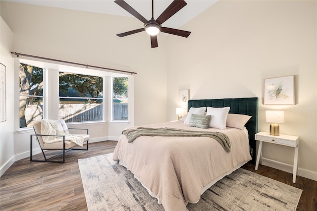 bedroom featuring a ceiling fan, wood finished floors, and baseboards