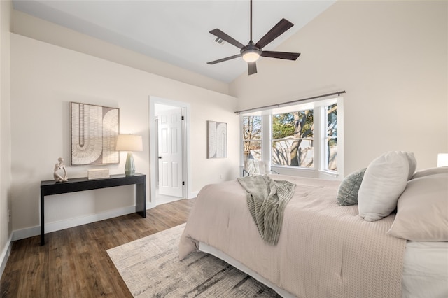 bedroom featuring baseboards, lofted ceiling, wood finished floors, and a ceiling fan