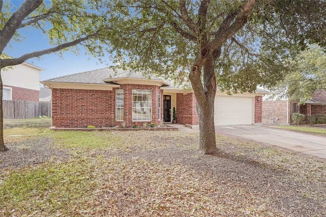 single story home featuring brick siding, driveway, a garage, and fence