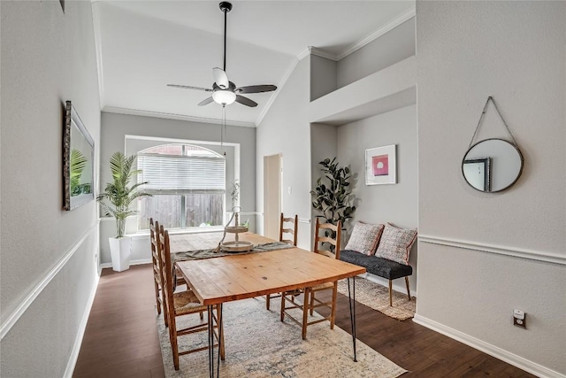 dining space with dark wood-style flooring, baseboards, lofted ceiling, and ornamental molding