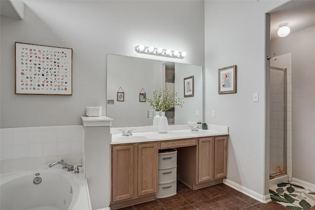 full bath featuring a sink, a shower stall, double vanity, baseboards, and a whirlpool tub