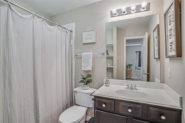 bathroom with curtained shower, toilet, and vanity