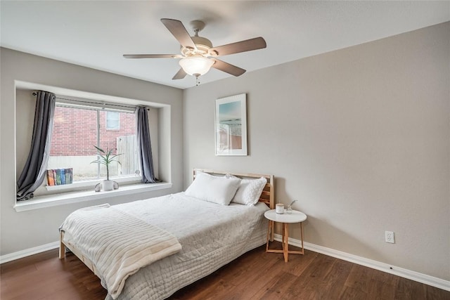 bedroom with wood finished floors, baseboards, and ceiling fan