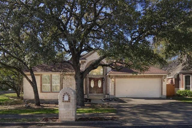 view of front facade featuring brick siding, concrete driveway, a garage, and a shingled roof