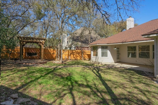 view of yard with a pergola, a patio area, and fence