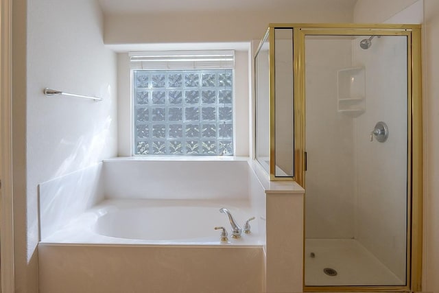 full bathroom with a garden tub and a stall shower