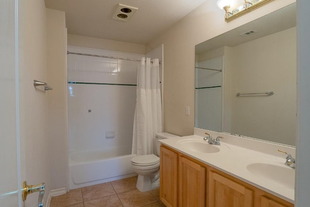 bathroom with tile patterned floors, visible vents, toilet, and a sink