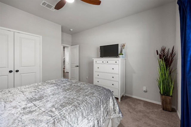 carpeted bedroom featuring visible vents, baseboards, a closet, and ceiling fan