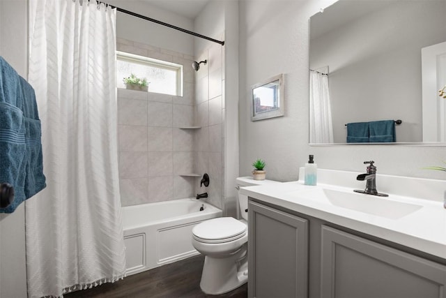 bathroom featuring vanity, toilet, wood finished floors, and shower / bath combo