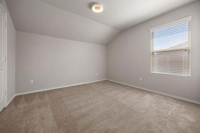 additional living space featuring vaulted ceiling, baseboards, and carpet floors