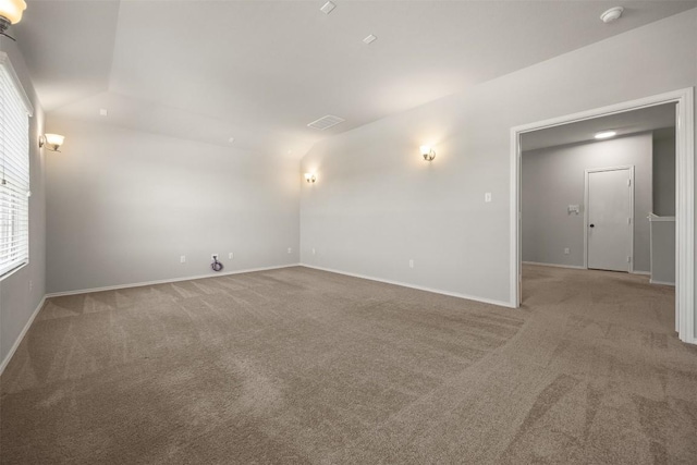 spare room with visible vents, carpet, and baseboards