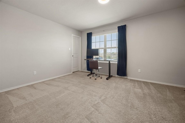 unfurnished office with light colored carpet and baseboards