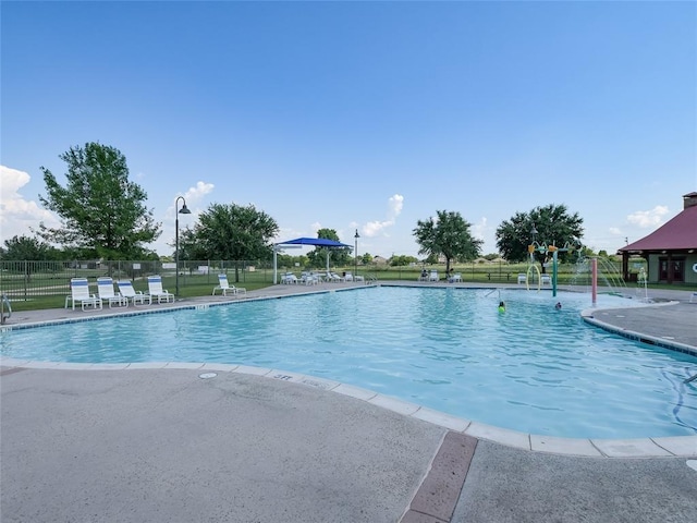 community pool featuring a patio and fence