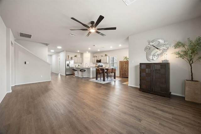 unfurnished living room with dark wood finished floors, recessed lighting, a ceiling fan, and visible vents