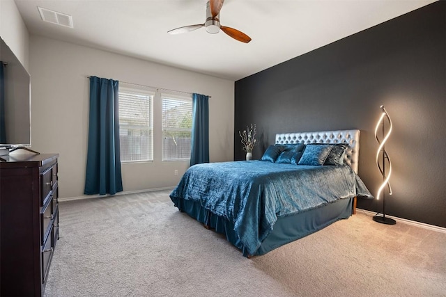 bedroom featuring light carpet, visible vents, and baseboards