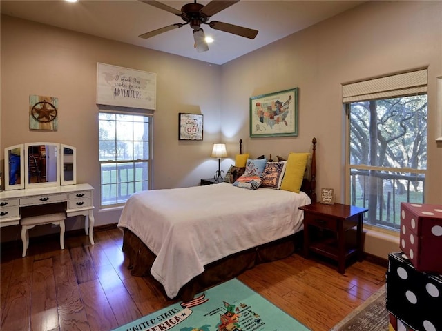 bedroom featuring hardwood / wood-style floors, baseboards, and ceiling fan