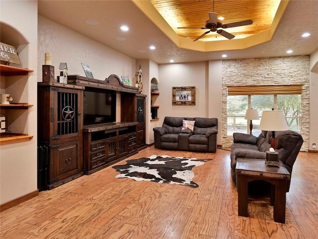 living room with a ceiling fan, recessed lighting, wooden ceiling, light wood finished floors, and a raised ceiling