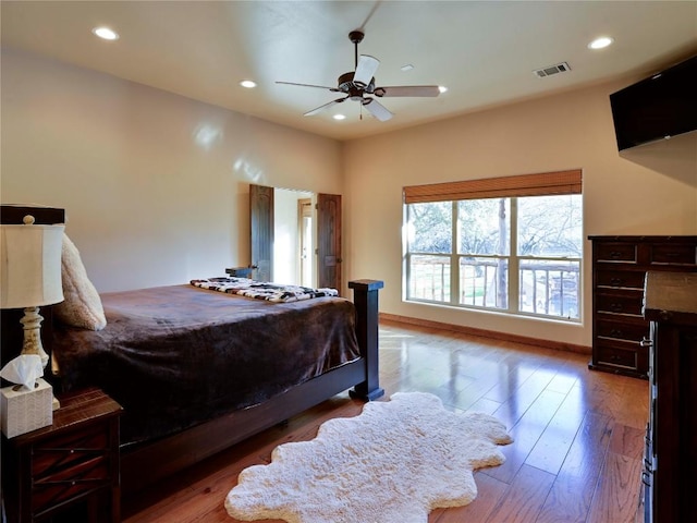 bedroom with recessed lighting, baseboards, and wood finished floors