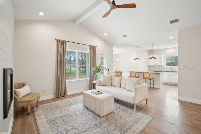 103 Manana Ct, Bastrop, TX 78602 - living area featuring beamed ceiling, light wood finished floors, a ceiling fan, recessed lighting, and high vaulted ceiling