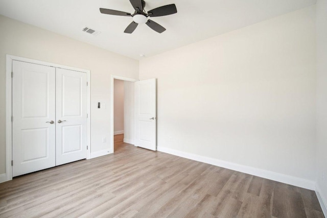 103 Manana Ct, Bastrop, TX 78602 - unfurnished bedroom with light wood-style floors, a closet, and a ceiling fan
