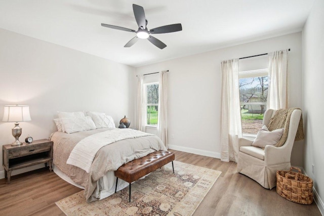 103 Manana Ct, Bastrop, TX 78602 - bedroom featuring light wood-type flooring, multiple windows, and a ceiling fan