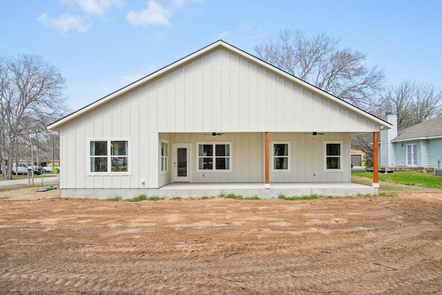 103 Manana Ct, Bastrop, TX 78602 - rear view of house featuring a ceiling fan, board and batten siding, and a patio area