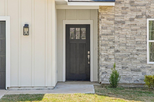 103 Manana Ct, Bastrop, TX 78602 - view of exterior entry with stone siding and board and batten siding