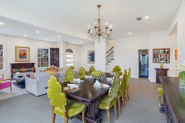 dining space with stairway, recessed lighting, visible vents, and a chandelier