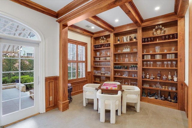 dining area with built in features, visible vents, wainscoting, crown molding, and beamed ceiling