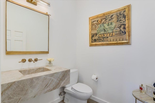 bathroom featuring toilet and a sink