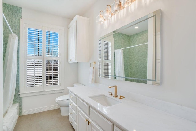 full bathroom with vanity, baseboards, tile patterned floors, toilet, and shower / tub combo with curtain