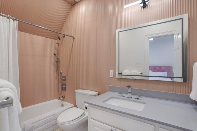 bathroom featuring vanity, shower / tub combo, and toilet