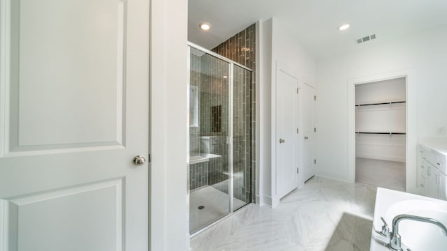 bathroom featuring visible vents, a stall shower, recessed lighting, baseboards, and a spacious closet