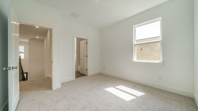 unfurnished bedroom with visible vents, baseboards, and carpet floors