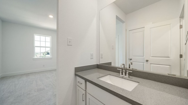 bathroom featuring vanity and baseboards