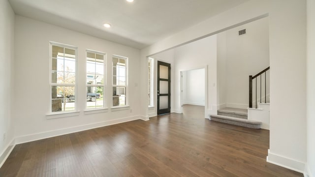 interior space featuring visible vents, stairs, baseboards, and dark wood-style flooring